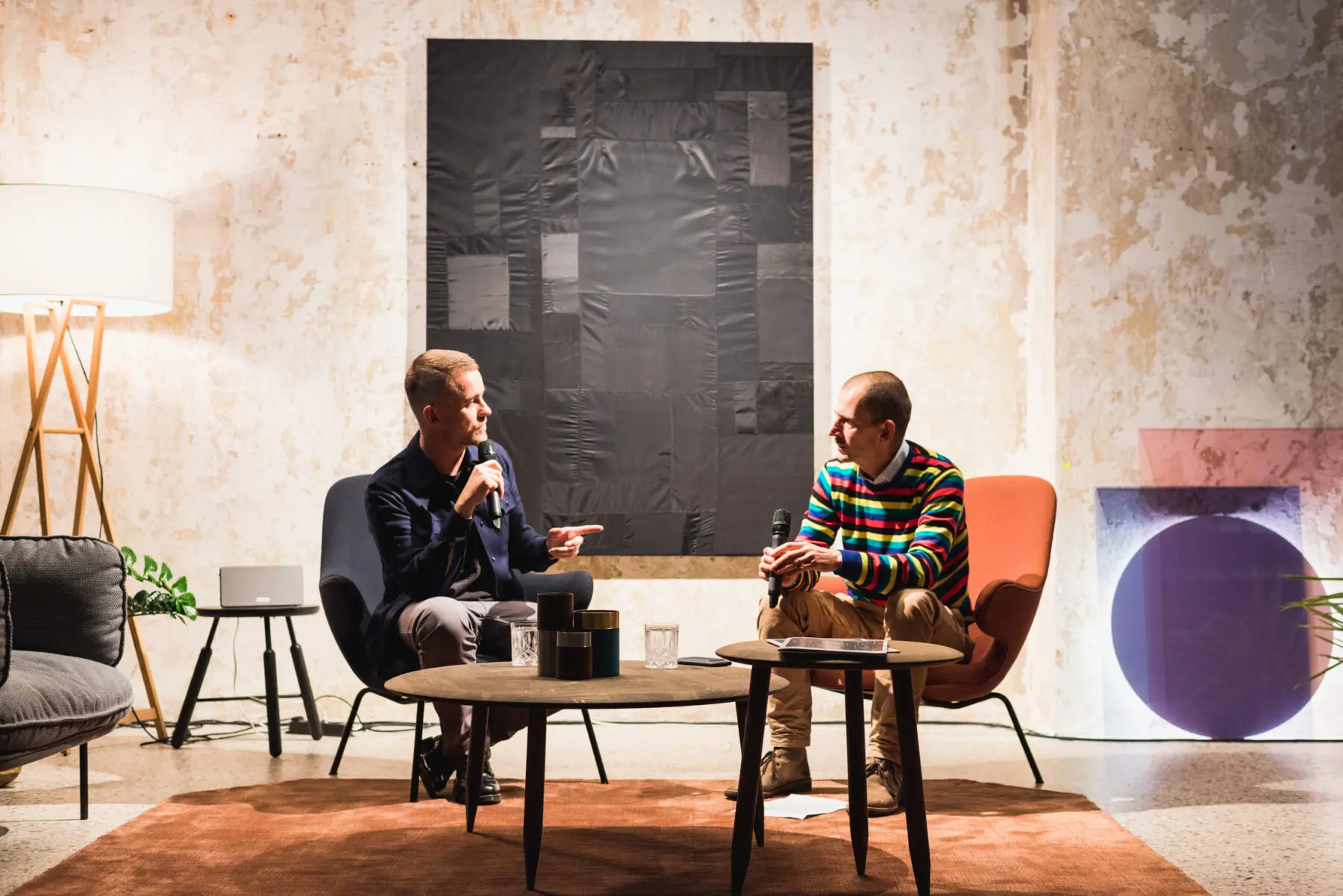 Two speakers in conversation during a talk