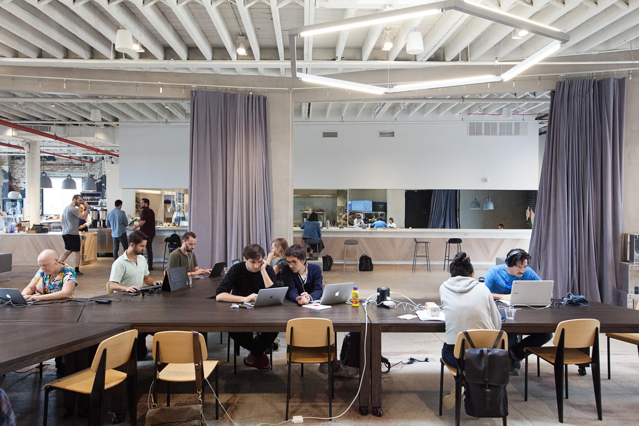 Guests working at long tables in the hall